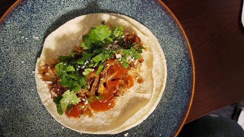 Bourbon Chicken Taco on White Corn Tortilla topped with Mango Habanero Salsa, Chopped Cilantro, and Cotija Cheese